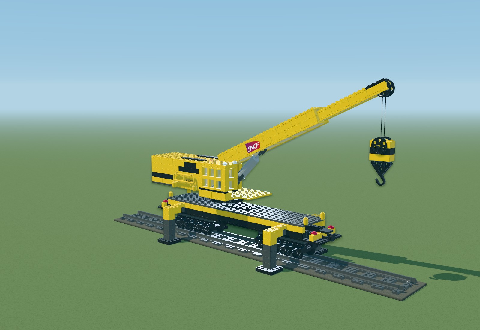 Yellow brick model of the Kirow railway crane, with eight axles, outriggers and a long lifting boom.