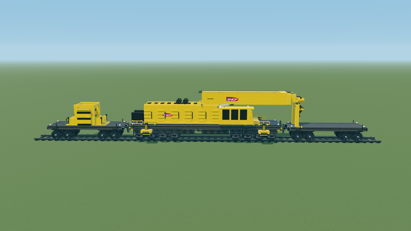 Brick interpretation of the SNCF Kirow train: a lowered crane between two wagons on a display track.